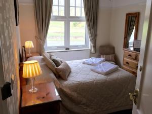 A bed or beds in a room at Meadowcroft Guest House