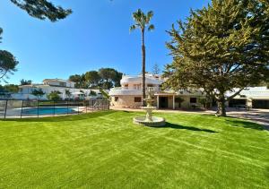 a large yard with a fountain in front of a house at Villa Maréa Private Luxury Villa in Santa Faz