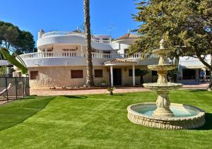a large house with a fountain in the yard at Villa Maréa Private Luxury Villa in Santa Faz