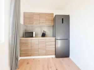 une cuisine avec un réfrigérateur et un micro-ondes dans l'établissement Tolstov Apartments - Monteurwohnung - 3 Schlafzimmer - Esszimmer - Küche - Waschmaschine - 25 Min zur Messe DUS, à Heiligenhaus