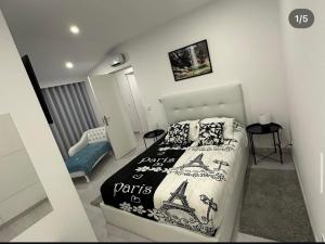 a bedroom with a bed with a black and white comforter at Best Gerês village in São Pedro +27 photos