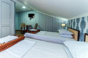 Letto o letti in una camera di HOTEL GUGLUX &WINE CELLAR