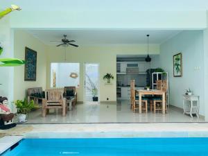 a living room and dining room with a pool at Villa WENHOMANN in Lovina