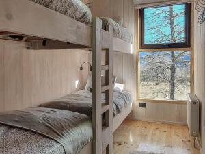 two bunk beds in a room with a window at Casa ss Malalcahuello in Malalcahuello