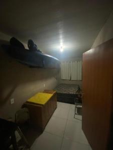 a small room with a bed and a plane on the wall at Los Arboles - Quarto com Banheiro in Alexânia