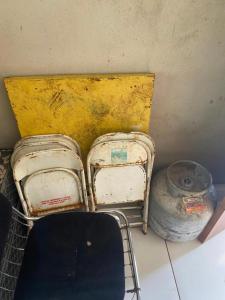 two old bags sitting on a floor next to a basket at Los Arboles - Quarto com Banheiro in Alexânia