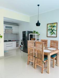 a kitchen with a table and chairs and a refrigerator at Villa WENHOMANN in Lovina