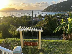 a porch swing with a view of a harbor at Cane Garden Bay 2 bed Apt in Leonards