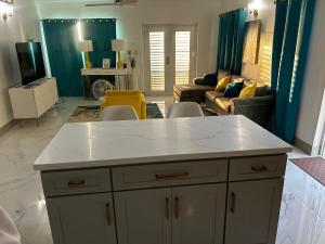 a kitchen and living room with a white counter top at Cane Garden Bay 2 bed Apt in Leonards