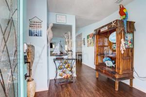 a room with a bird sitting on top of a wooden cabinet at 2706 W, 3rd St home in Fernandina Beach