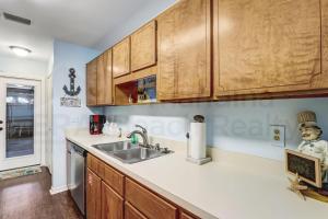 a kitchen with wooden cabinets and a sink at 2706 W, 3rd St home in Fernandina Beach +25 photos