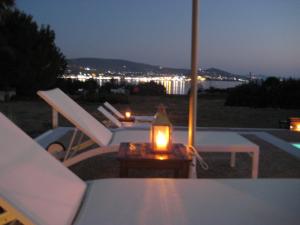 eine Kerze auf einem Tisch auf einer Terrasse in der Nacht in der Unterkunft Roses Beach in Parikia