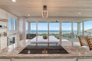 a kitchen with a large island with a view of the ocean at 226 SF 2nd Floor townhouse in Fernandina Beach +38 photos