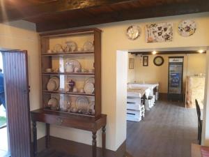 a dining room with plates and dishes on shelves at Hospedaje CASABLANCA URUBAMBA in Urubamba