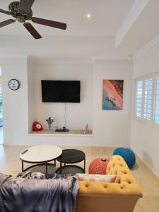 a living room with a couch and a table at Spacious Serene Luxury Retreat in Narre Warren South