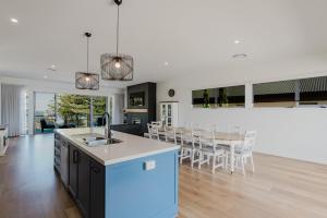 a kitchen and living room with a table and chairs at The Dual Family Entertainer 9 Esplanade Victor Harbor - Linen Included - Luxury - Seafront in Victor Harbor