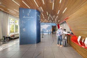 a man is standing in a lobby with a blue wall at Amazing Studio Cozy at the Beach close to Mall in Hallandale Beach +50 photos