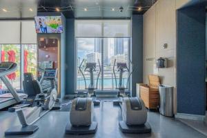 a gym with cardio equipment and a large window at Amazing Studio Cozy at the Beach close to Mall in Hallandale Beach