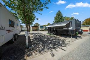 a trailer and a camper parked next to a truck at Albury Holiday Park in Albury
