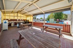 a pavilion with two wooden benches in a building at Albury Holiday Park in Albury