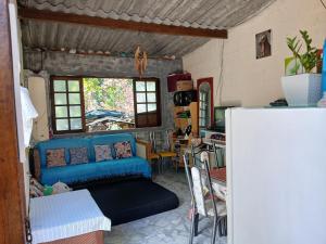 a living room with a blue couch and a table at Recanto alegria in São Roque