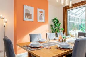 a dining room with a wooden table and chairs at Luccombe Lodge in Southampton