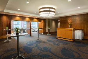 a conference room with a podium and a table at Coast Coal Harbour Vancouver Hotel by APA in Vancouver