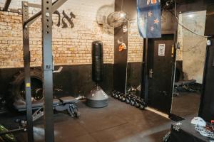 a gym with a fire extinguisher in a room at Auckland Boutique Capsule in Auckland