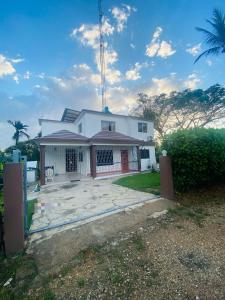a white house with a large driveway at Kassuky Home in Cabarete