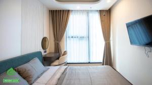 a hotel room with a bed and a large window at Thuý Doji Diamond Apartment in Hai Phong