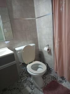 a bathroom with a white toilet and a sink at Departamento Monoambiente Centro Villa Carlos Paz in Villa Carlos Paz +20 photos