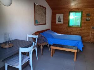 a bedroom with a bed and a table and chairs at Maisonnette individuelle proche centre pour 2 personnes avec jardin privatif - FR-1-476-5 in La Faute-sur-Mer