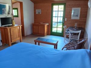 a bedroom with a bed and a table and a television at Maisonnette individuelle proche centre pour 2 personnes avec jardin privatif - FR-1-476-5 in La Faute-sur-Mer
