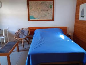 a room with a bed and a chair and a map at Maisonnette individuelle proche centre pour 2 personnes avec jardin privatif - FR-1-476-5 in La Faute-sur-Mer