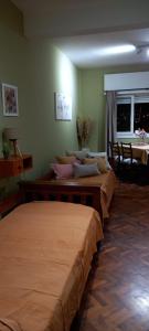 a room with three beds in a room at Departamento Monoambiente Centro Villa Carlos Paz in Villa Carlos Paz