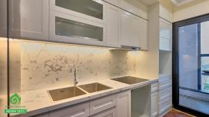 a kitchen with white cabinets and a sink at Thuý Doji Diamond Apartment in Hai Phong