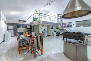 a kitchen and dining room with a table and a stove at Luxury mansion in Recoleta - Jacuzzi - Sauna - 40 people in Buenos Aires