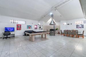 a large room with a pool table and chairs at Luxury mansion in Recoleta - Jacuzzi - Sauna - 40 people in Buenos Aires