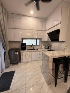 a large kitchen with white cabinets and a sink at Villa Daliya Private Pool Langkawi in Langkawi Intl