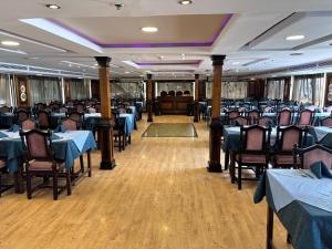 a dining room with tables and chairs and blue tables at مركب ريفر بوت River Boat in Cairo