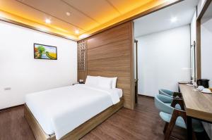 Postel nebo postele na pokoji v ubytování A25 Hotel - 21 Nghia Tan
