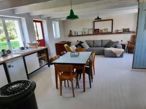 a kitchen and living room with a table and chairs at Maison charmante au calme avec jardin à Kerlard - FR-1-813-24 in Groix