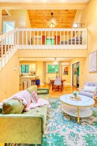 a living room with a couch and a table at Grand Woodland Retreat - Hot Tub - Game Room in Gouldsboro +28 photos