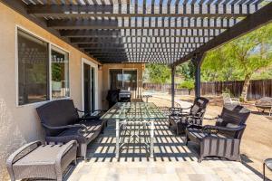 a patio with chairs and a glass table on a patio at Desert Escape Home with 3BD 3BA with Pool and Jacuzzi in Wildomar