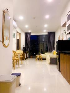 a bedroom with a bed and a living room at Lahomestay Chỗ Nghỉ 2PN Tiện Nghi, Khách Hàng Yêu Thích in Tân Vạn