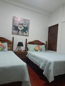 Een bed of bedden in een kamer bij Hotel Casa de Copan