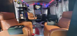 a train car with orange seats and a television at Cozy Mobiles Luxury Living Room and Dine On Wheels in Arlington