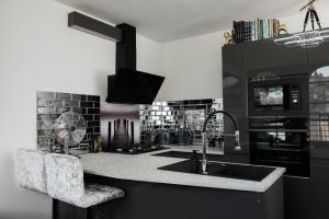 a kitchen with a sink and a stove at The Residence in Kendal