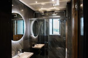 a bathroom with two sinks and a mirror at The Residence in Kendal +7 photos