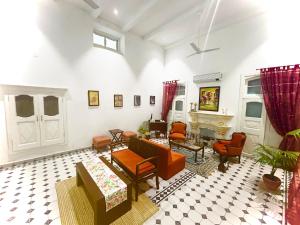 a living room with couches and chairs at Grand Villa in Amritsar